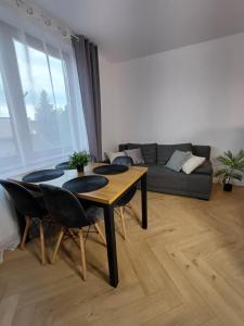 a living room with a table and a couch at Wieliczka4You in Wieliczka