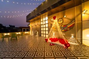 a figurine of a bride in a dress on a building at palm hotel mansarovar in Jaipur