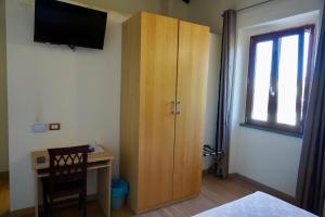 a bedroom with a desk and a large wooden cabinet at La Rosa Garden in Campi Bisenzio +31 photos