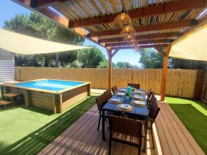 a patio with a table and a swimming pool at NEW Family Villa ideal para familias in Pineda de Mar