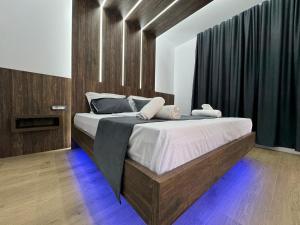 a bedroom with a large bed in a room at Infinity Suites Pushi in Ksamil