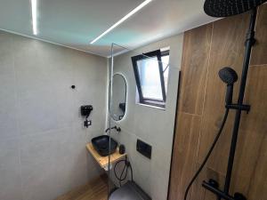 a room with a microphone and a mirror on the wall at Infinity Suites Pushi in Ksamil