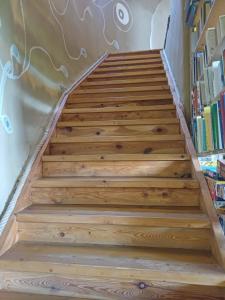 a set of stairs with a book shelf at Okrągła Chata in Morzyszów