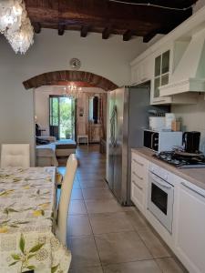 a kitchen with a table and a dining room at la casa di Debora in Arezzo