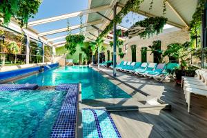 a swimming pool with lounge chairs and a swimming pool at Hotel Regal in Costinesti