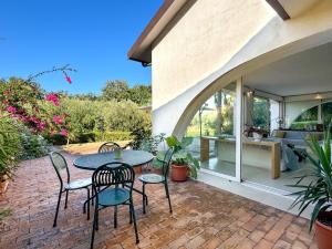 a patio with a table and chairs on a brick patio at Approdo in Ortona