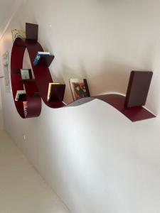 a shelf on a wall with a computer on it at Hello Bronte! in Sydney