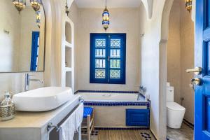 a bathroom with a tub and a sink and a bath tub at Traditional Villa Dar Izza - 4 suite with breakfast in Douar Soukkane +95 photos