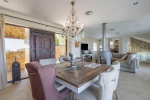 a dining room and living room with a table and chairs at Sa Punta 99 F2 in Begur