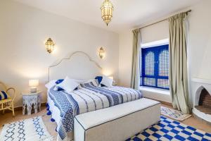 a bedroom with a bed and a fireplace at Traditional Villa Dar Izza - 4 suite with breakfast in Douar Soukkane