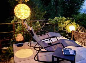 a patio with two chairs and a table and lights at Maramare Pinus in Stara Baška +11 photos