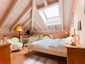 a bedroom with a bed and a skylight at Locanda L'Amorosa in Sementina