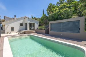 a swimming pool in front of a house at Sa Punta 99 F2 in Begur