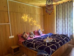 a bedroom with a bed with a teddy bear on it at Meet by cooincidence homestay - A place of peace and nature in Shangarh