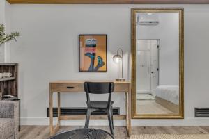 a desk with a chair and a mirror at La Sainte Paix in Quebec City +77 photos