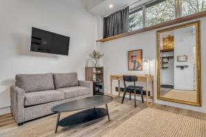 a living room with a couch and a table and a mirror at La Sainte Paix in Quebec City