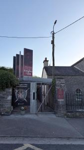 a building with a sign on the side of it at Double en-suite in Glin
