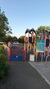 a playground in a park with a roller coaster at Double en-suite in Glin