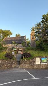 an old stone building with a church on a hill at Double en-suite in Glin +28 photos