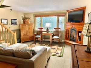 a living room with a couch and a fireplace at The Interlaken Inn in Lake Placid