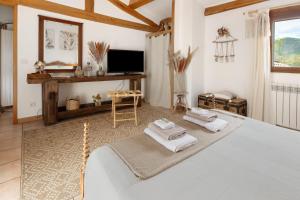 a bedroom with a bed with towels on it at Le Mas de la Rode in Saumane