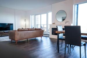 a living room with a couch and a table at 310 - Luxury Condo The Serenity - View and Pool in Baie-Saint-Paul +47 photos