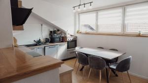 a kitchen with a table and chairs in a room at Gacka idila 2 in Otočac