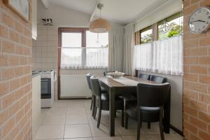 a kitchen and dining room with a table and chairs at Rekerlanden 187 in Schoorldam
