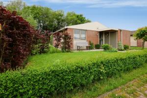 a brick house with a lawn in front of it at Rekerlanden 187 in Schoorldam