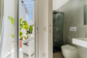 a bathroom with a toilet and a sink and a shower at Baia Di Torre Squillace in Sant'Isidoro