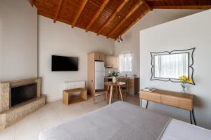 a living room with a bed and a kitchen at Anassia Villas in Nafplio