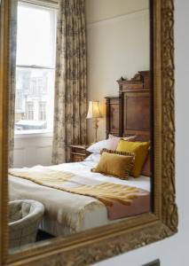 a mirror reflection of a bed in a bedroom at The Falcon Hotel in Uppingham