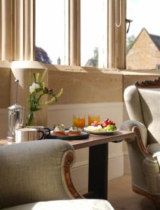 a table with a plate of food on it in a window at The Falcon Hotel in Uppingham