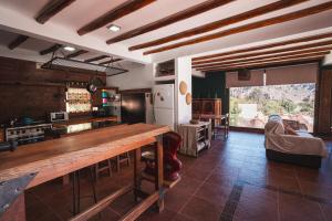 a kitchen with a large wooden table in a room at La Llama Negra in Tilcara
