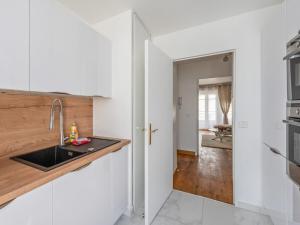 a kitchen with a sink and a counter top at Cour Royale Disneyland Paris in Chessy +17 photos