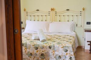 a bed with two pillows on top of it at Tenuta Villa Tara in Sant'Angelo D'Ischia +49 photos