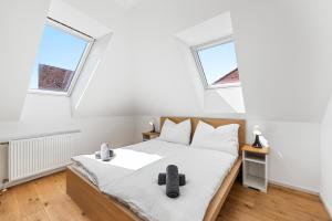 a bedroom with a bed and two windows at Stiftblick Residence Melk in Melk