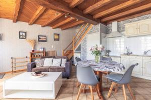 a kitchen and a living room with a table and chairs at Chez Catherine Et Gérard in Tonnay-Charente +17 photos