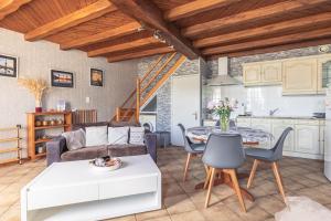 a living room with a couch and a table at Chez Catherine Et Gérard in Tonnay-Charente