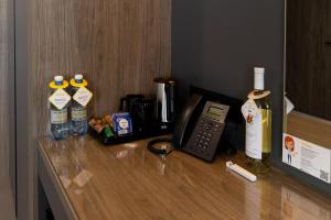 a hotel room counter with a phone and bottles of alcohol at Житомир by Optima in Zhytomyr
