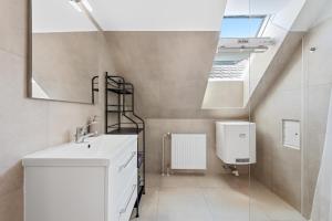 a bathroom with a sink and a skylight at Stiftblick Residence Melk in Melk +19 photos
