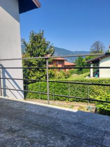 a view from the balcony of a house with a fence at B&B Le Colombine in Abbadia Lariana