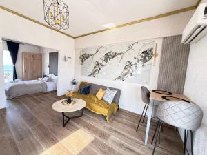 a room with a bed and a couch and a table at Beachfront Studio with Panoramic Sea View 2 in Ialysos