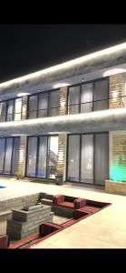 a large building with red chairs in front of it at Green Vista in Māḩiş