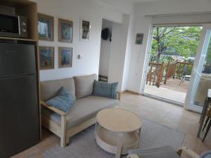 a living room with a couch and a table at Myrtos Hidden Garden Villa in Ierapetra +23 photos