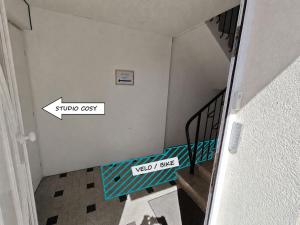 a view of a staircase with two signs on the wall at Studio cosy proche du centre-ville in Paray-le-Monial