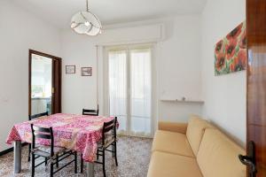 a living room with a table and a couch at Isonzo Holiday Home - 2 bedrooms in Loano