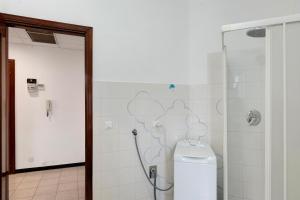 a bathroom with a shower and a toilet in it at Isonzo Holiday Home - 2 bedrooms in Loano +13 photos