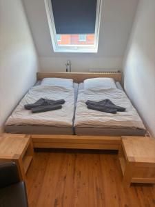 a bed with two shoes on it in a room at Ferienwohnung Fortuna in Borkum