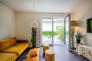 a living room with a couch and a table at Dünenquartier Apartment 24 in Zingst